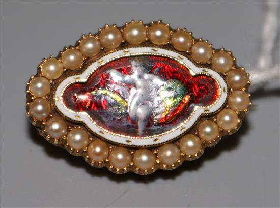 Victorian enamel and seed pearl yellow metal brooch decorated with a cherub